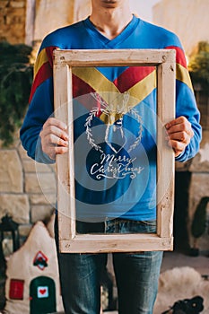 Man holding box with text Christmas glass