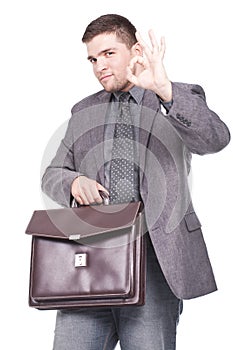 Man holding a briefcase and making ok sign