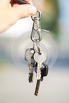 Man holding bunch of keys on blurred background