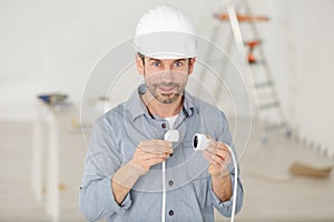 man holding cable plugs