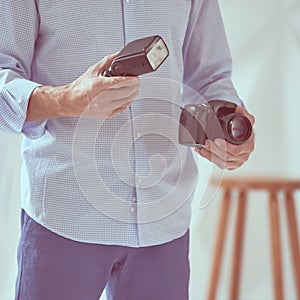 Man holding camera and flash