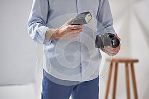 Man holding camera and flash