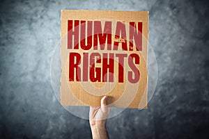 Man holding cardboard paper with HUMAN RIGHTS title photo