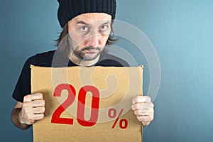 Man holding cardboard paper with sales discount price