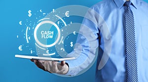 Man holding Cash Flow words with currency symbols. Finance concept