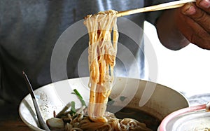 Man holding chopstick with