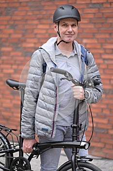 Man holding a city bicycle