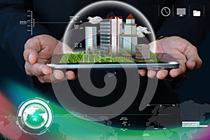 Man holding a cityscape in tablet computer