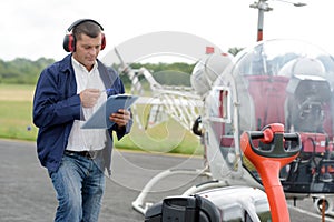 man holding clipboard by gyrocopter photo