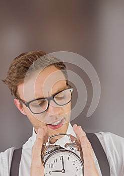 man holding clock in front of blurred background
