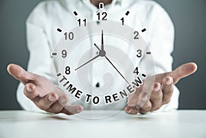 Man holding clock. Time To Renew