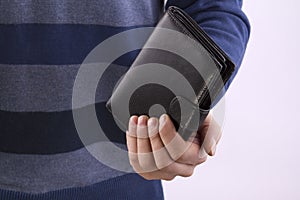 Man holding a closed wallet