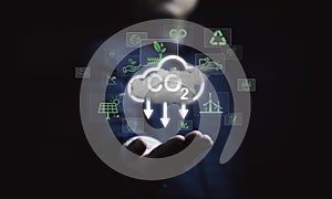 Man holding cloud with CO2 reducing icon for decrease CO2 , carbon footprint and carbon credit to limit global warming from