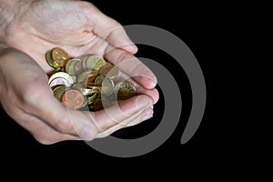 Man holding coins with both hands together. Euro money.