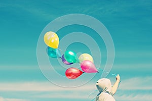 Man holding colorful balloons