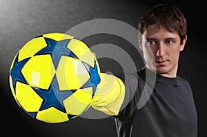 Man holding a colorful soccer ball in hand