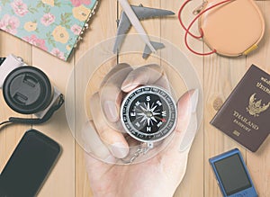 Man holding a compass for travel accessories