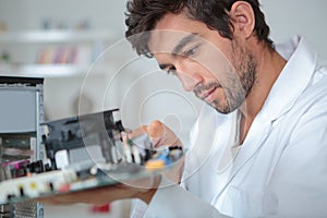 Man holding computer internals