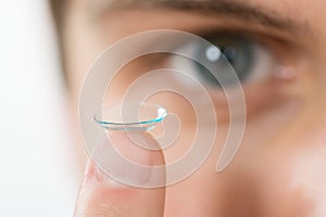 Man Holding Contact Lens On Finger