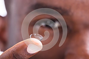 Man Holding Contact Lens In His Finger