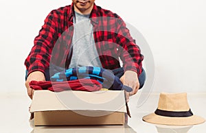 Man holding a crate of second-hand clothes unused clothes