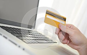 Man holding credit card in hand online shopping and banking