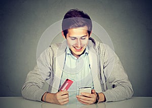 Man holding credit card smart phone for internet shopping