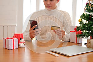 man holding credit card & smart phone for online shopping. male