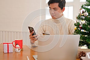 man holding credit card & smart phone for online shopping. male