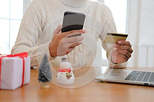 man holding credit card & smart phone for online shopping. male