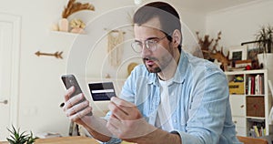 Man holding credit card use cellphone buy goods on internet