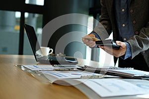 man holding credit card using smart phone for online shopping. b