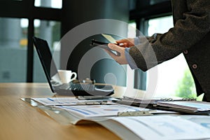 man holding credit card using smart phone for online shopping. b