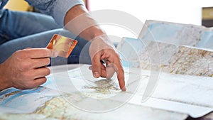 Man holding credit card on world map background