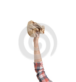 Man holding crumpled paper bag isolated on white, closeup