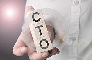 Man holding cto word on wooden cube