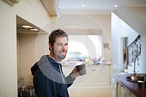 Man holding a cup of coffee at home