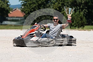 Man Is Holding Cup Speed Karting Race