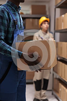 Man holding customer parcel in mail sorting center warehouse