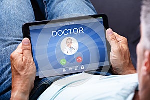 Man Holding Digital Tablet With Doctor`s Call On Display