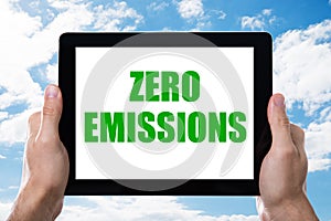 Man Holding Digital Tablet With Zero Emissions Text On Screen