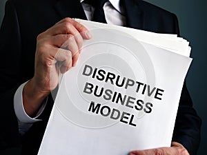 Man is holding Disruptive Business Model report