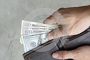 Man holding dollar banknote.young businessman holding money.Business and finances making and saving money concept