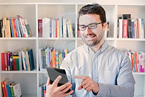 Man holding an e-book reader in hands