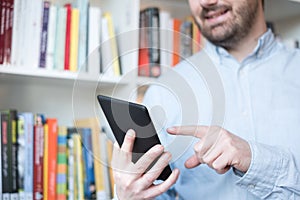 Man holding an e-book reader in hands