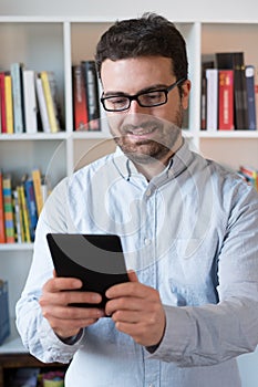 Man holding an e-book reader in hands