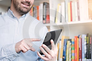 Man holding an e-book reader in hands