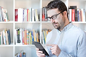 Man holding an e-book reader in hands