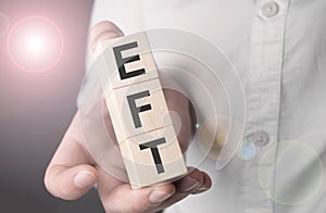 Man holding eft word on wooden cube