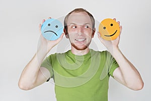 Man holding emotion smile symbols